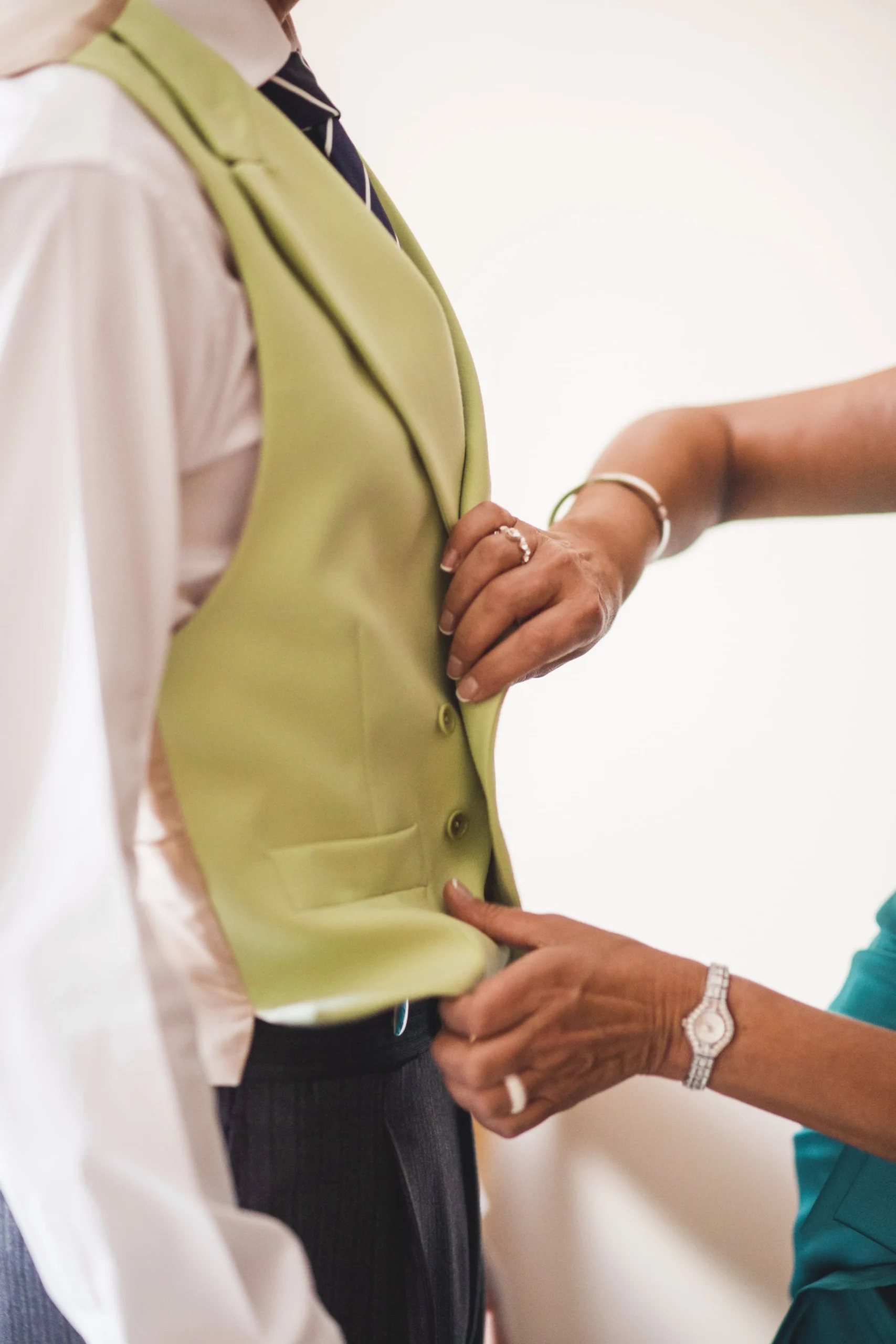 A K&K Couture Tailor makes alterations of yellow waistcoat