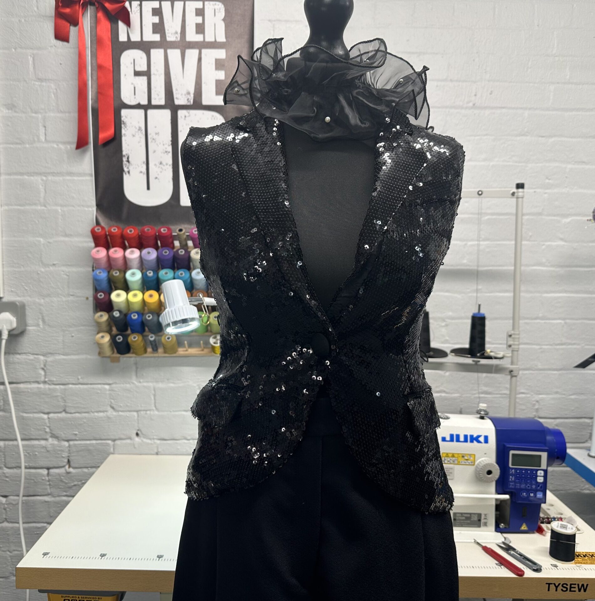 bespoke womens waistcoats made of black material with sequins, displayed on a dress form. made by k&k couture