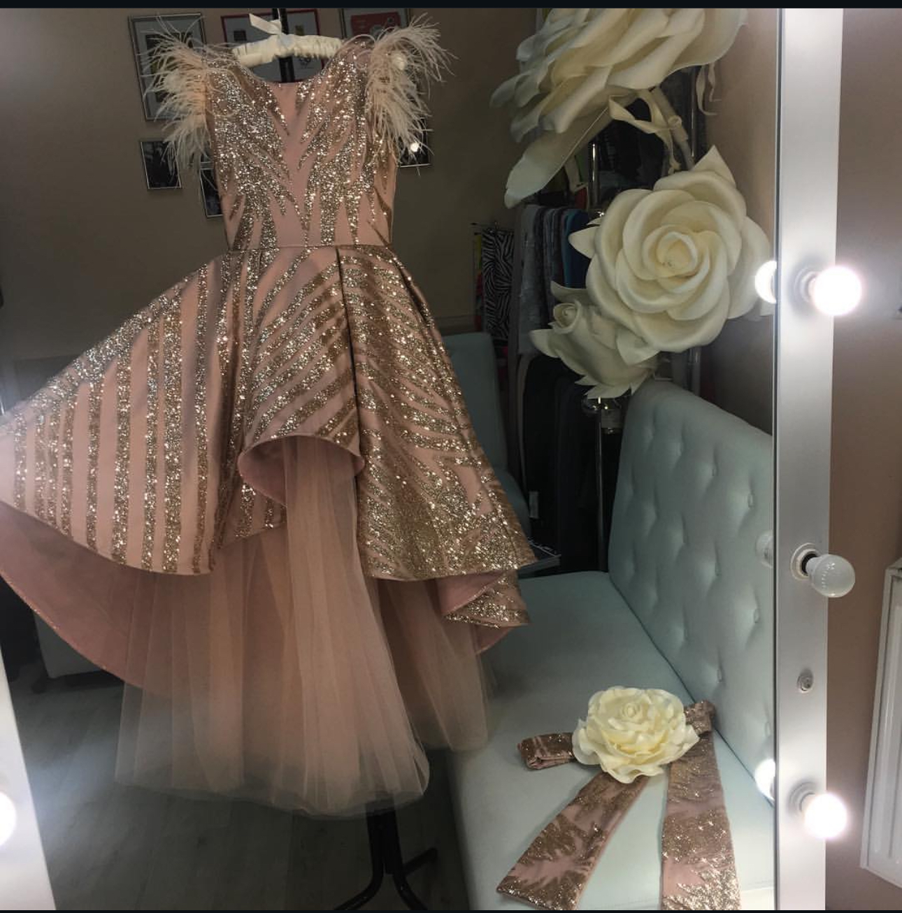 A chocolate brown bespoke gown on a studio mannequin, featuring Swarovski crystal embellishments and a layered tulle skirt, by K&K Couture London.