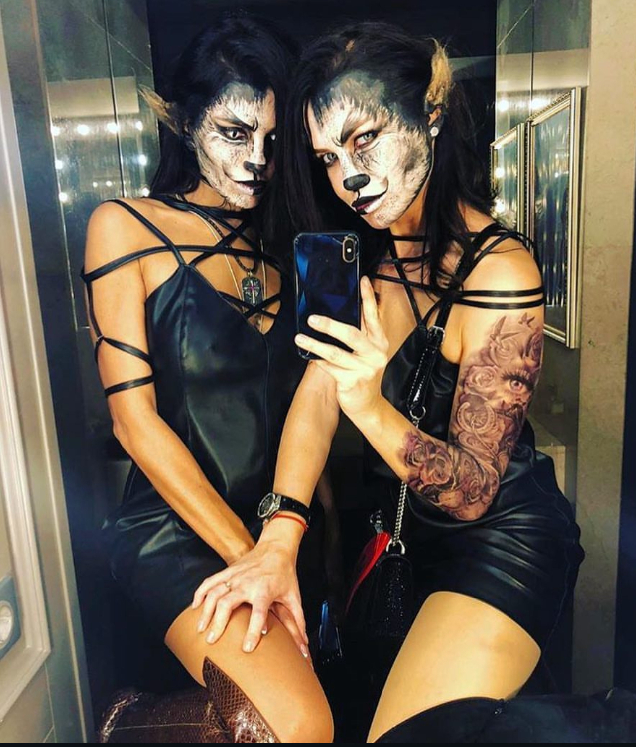 two ladies in cosplay cat costumes making selfie