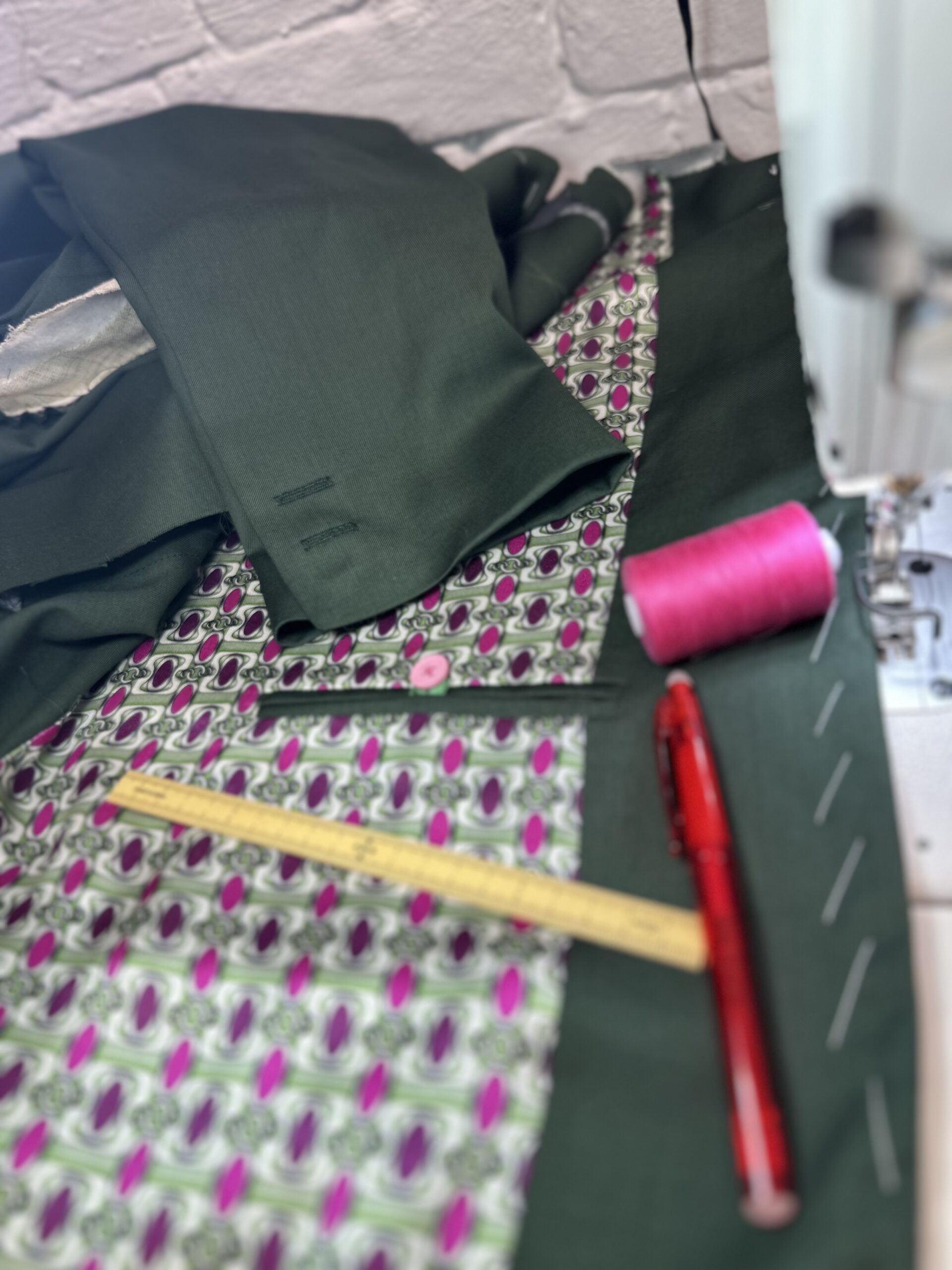 A bespoke black suit with a vibrant coloured lining, in the process of creation at K&K Couture's London atelier.