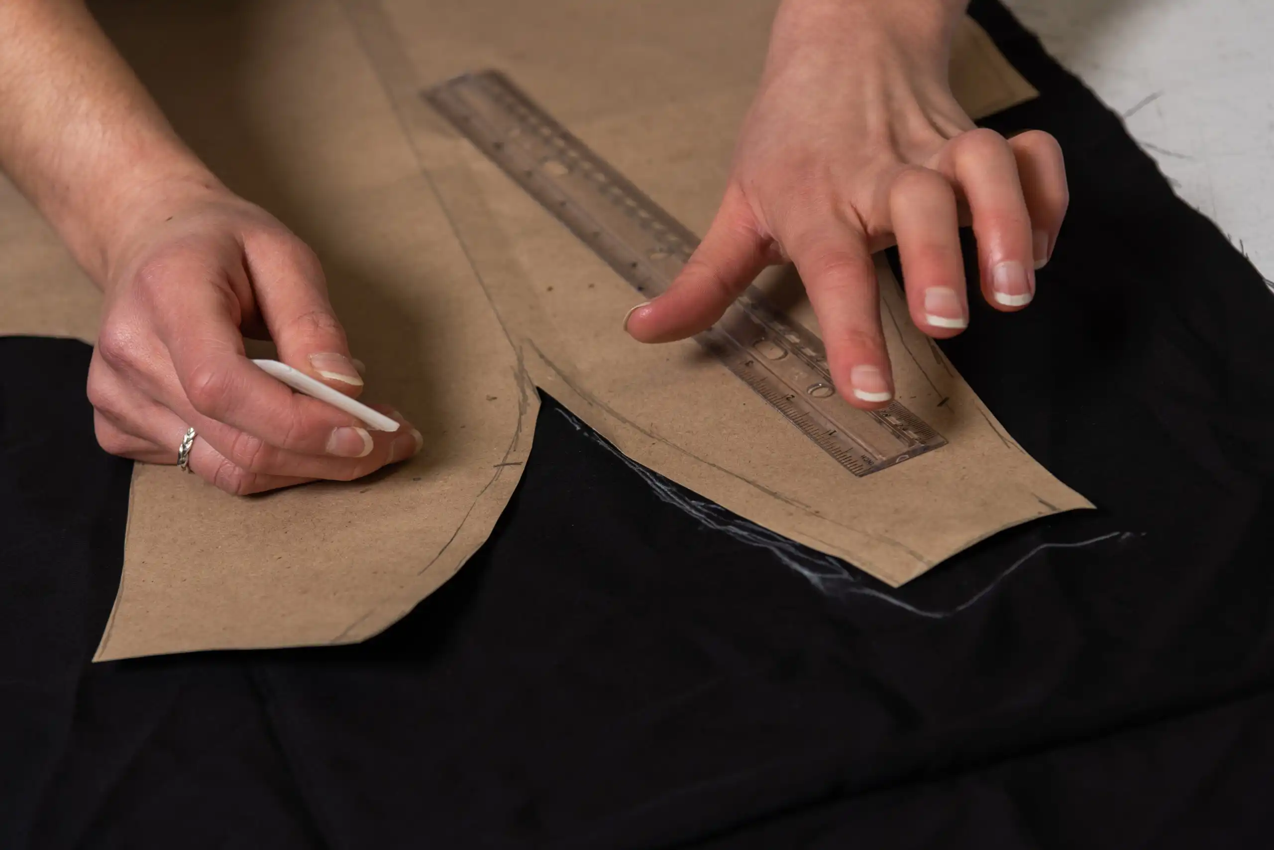 Clothing Alterations: A tailor pinning a garment during a fitting in London