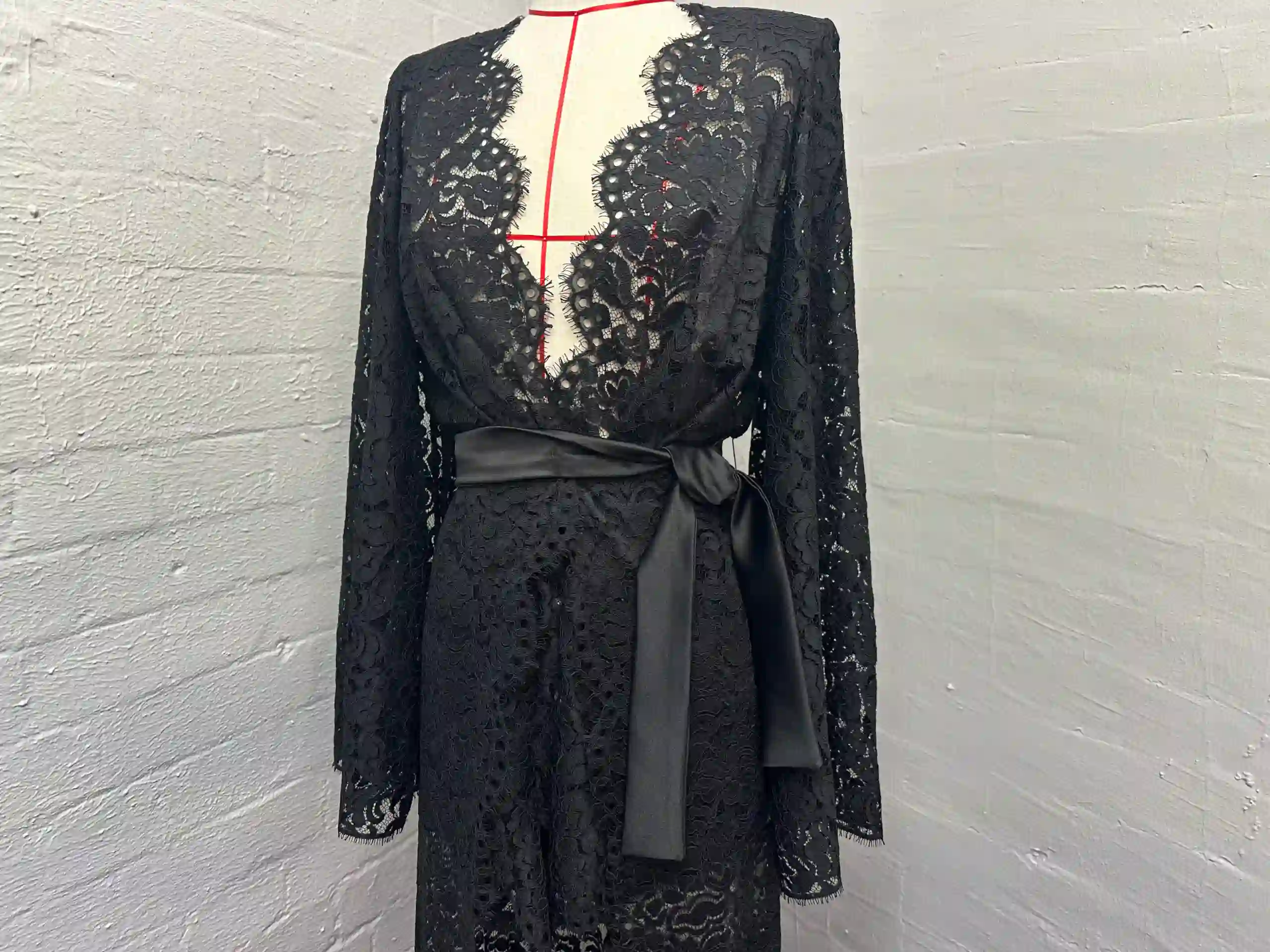 Evening Dress Alterations: A tailor pinning the hem of a formal gown in London.